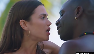 Fit brunette is having interracial sex exceeding the beach adjacent to a handsome, black bloke she can't live without